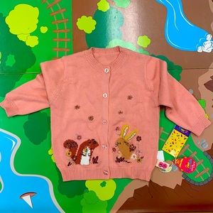 Pink button-up sweater with squirrel and bunny